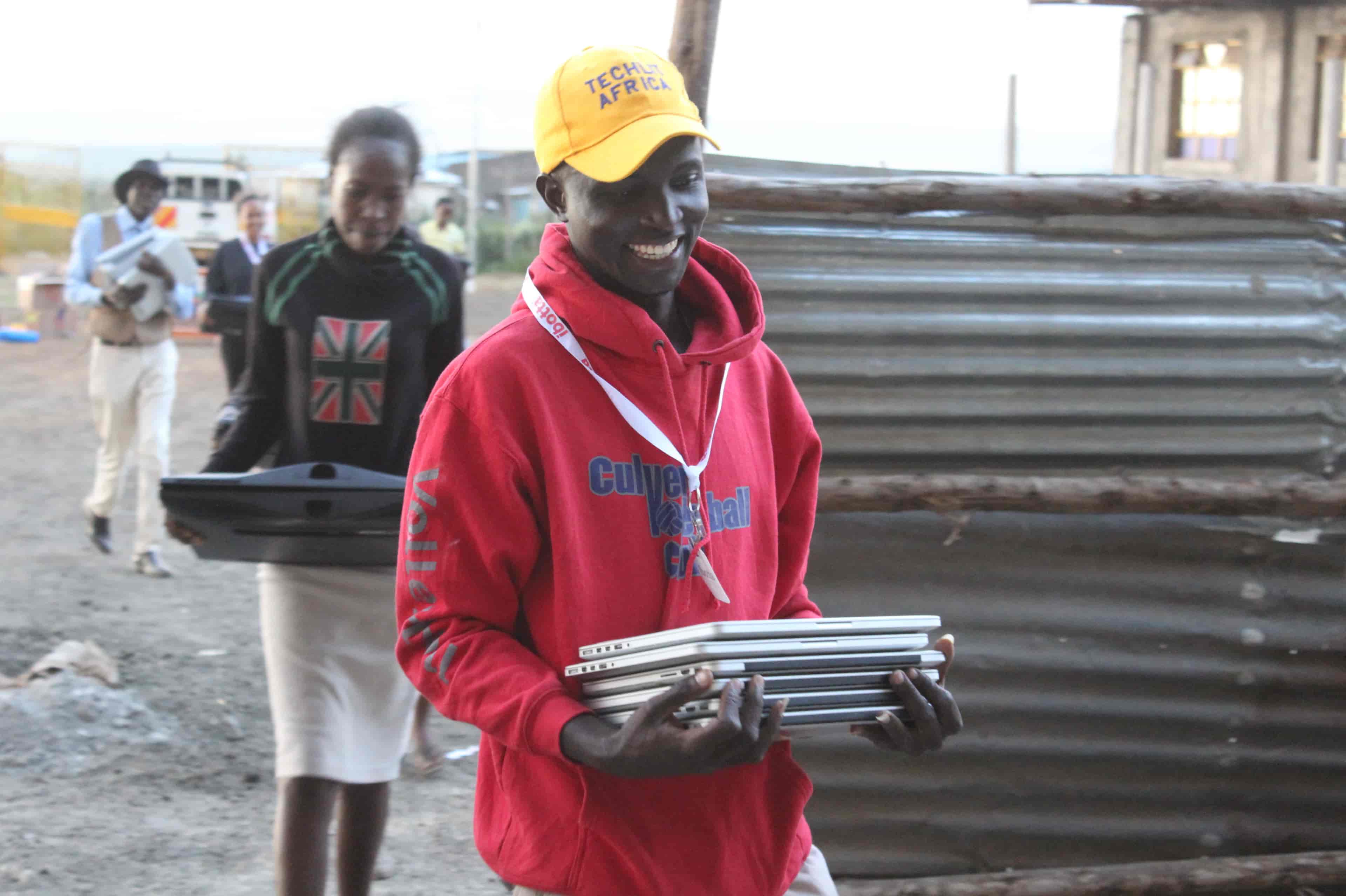 TechLit Africa team carrying old mac laptops for reuse