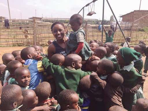 Nelly Cheboi with a crowd of kids at Zawadi Prep