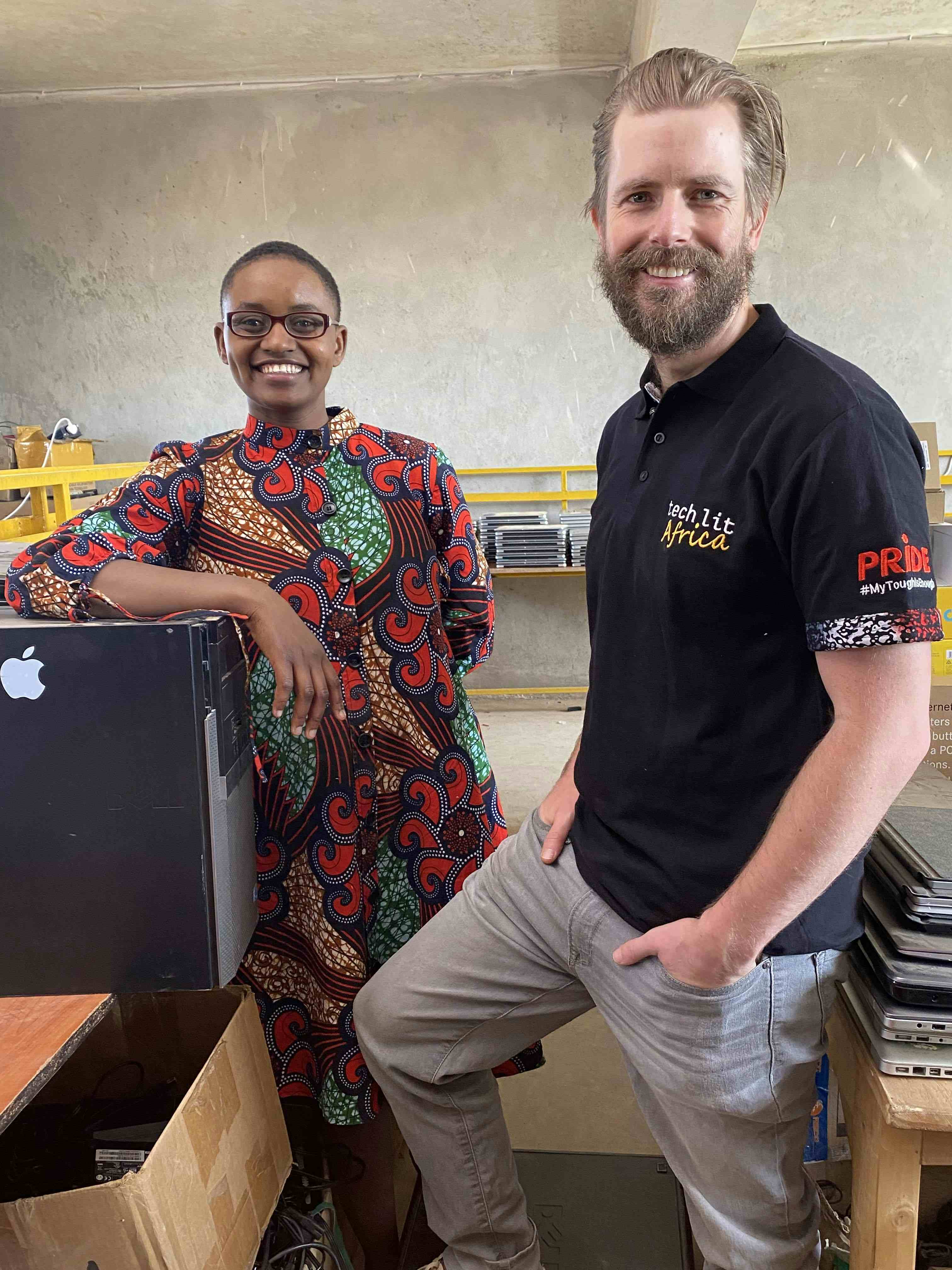 Nelly Cheboi and Tyler Cinnamon standing infront of computers at TechLit HQ