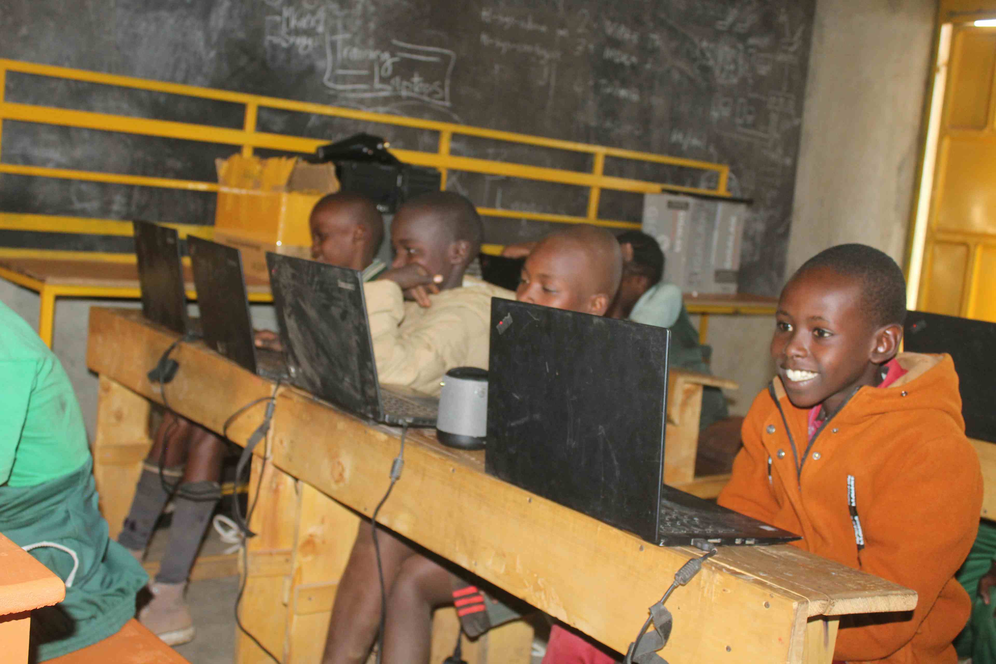 Kevin a student at Zawadi Yetu smiling at a zoom call during a NASA inkscape at TechLit Hub