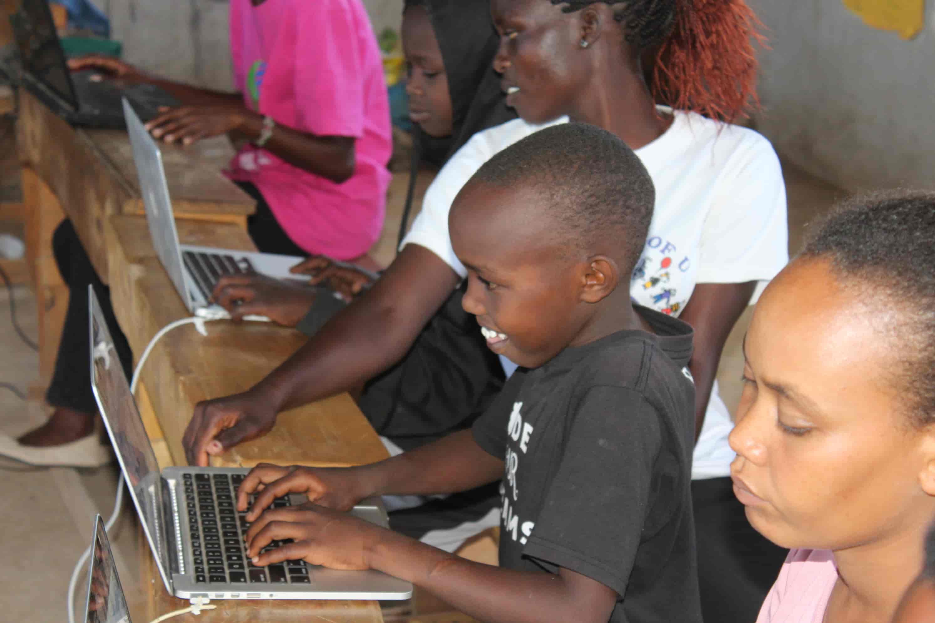 Primary school student motivated to learn on a repurposed mac laptop