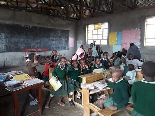 Primary school Kids at Zawadi Preparatory waving hello