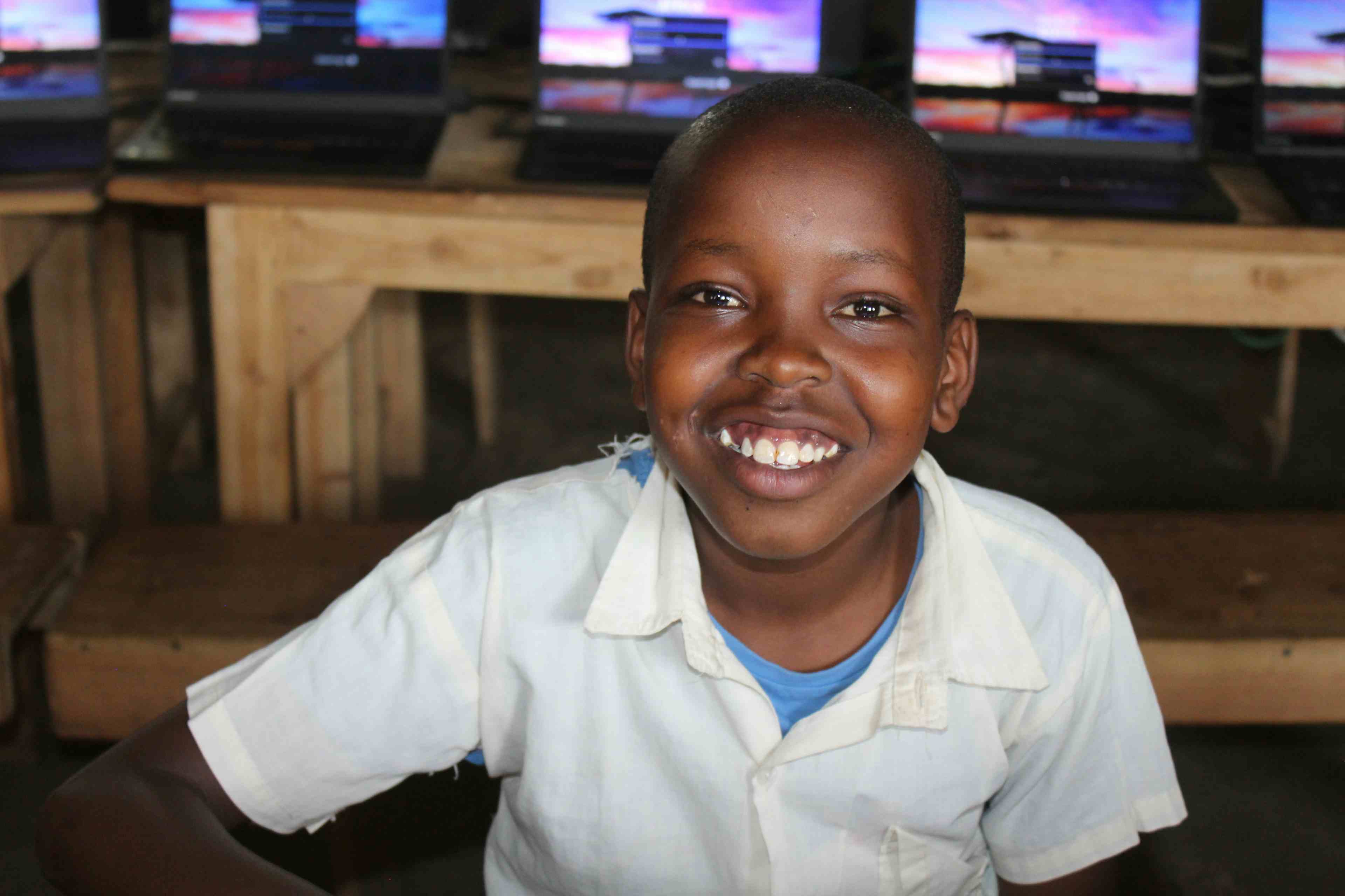 Proud Primary School Student With Laptops